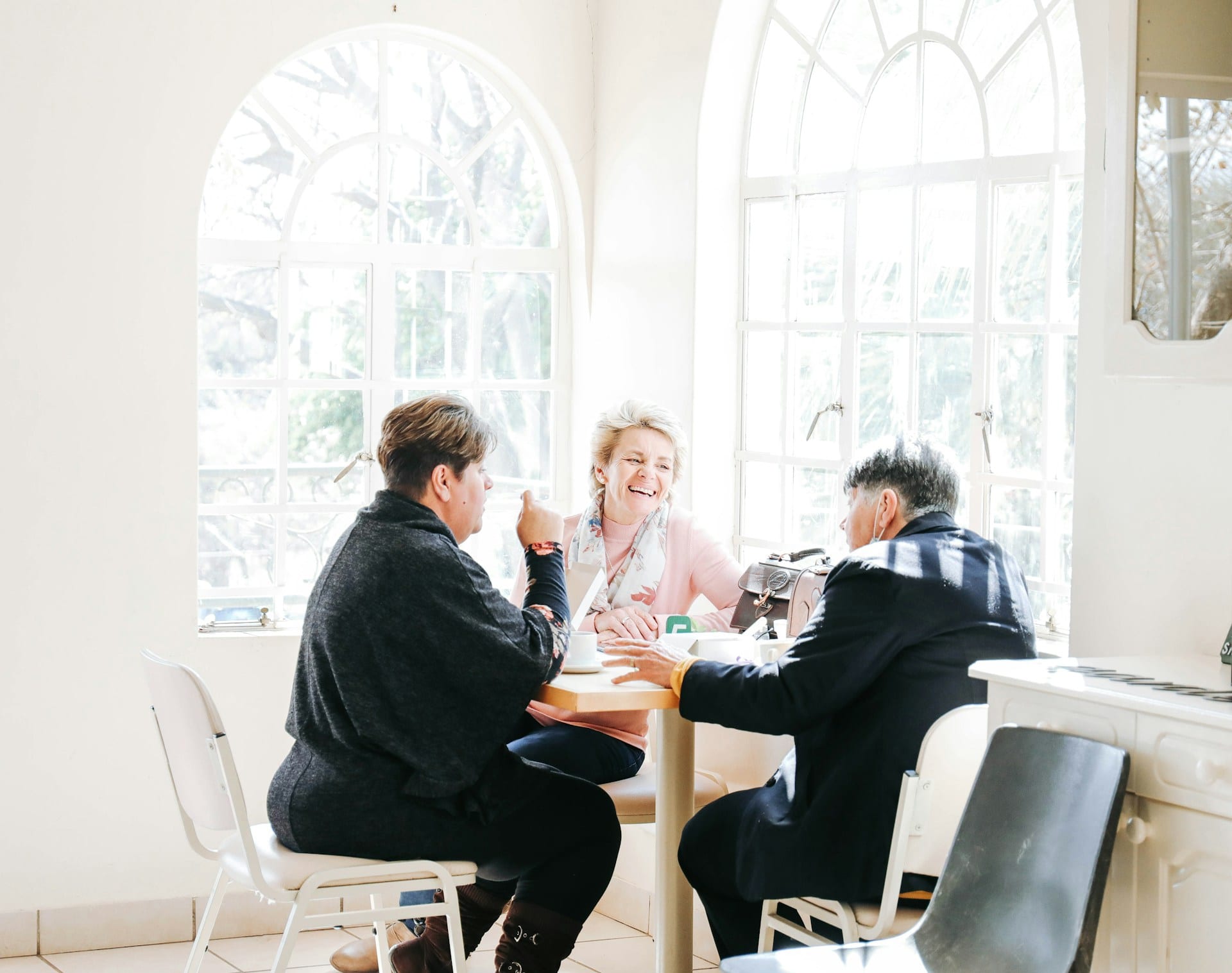 Auscare team members in conversation in a bright, welcoming workspace